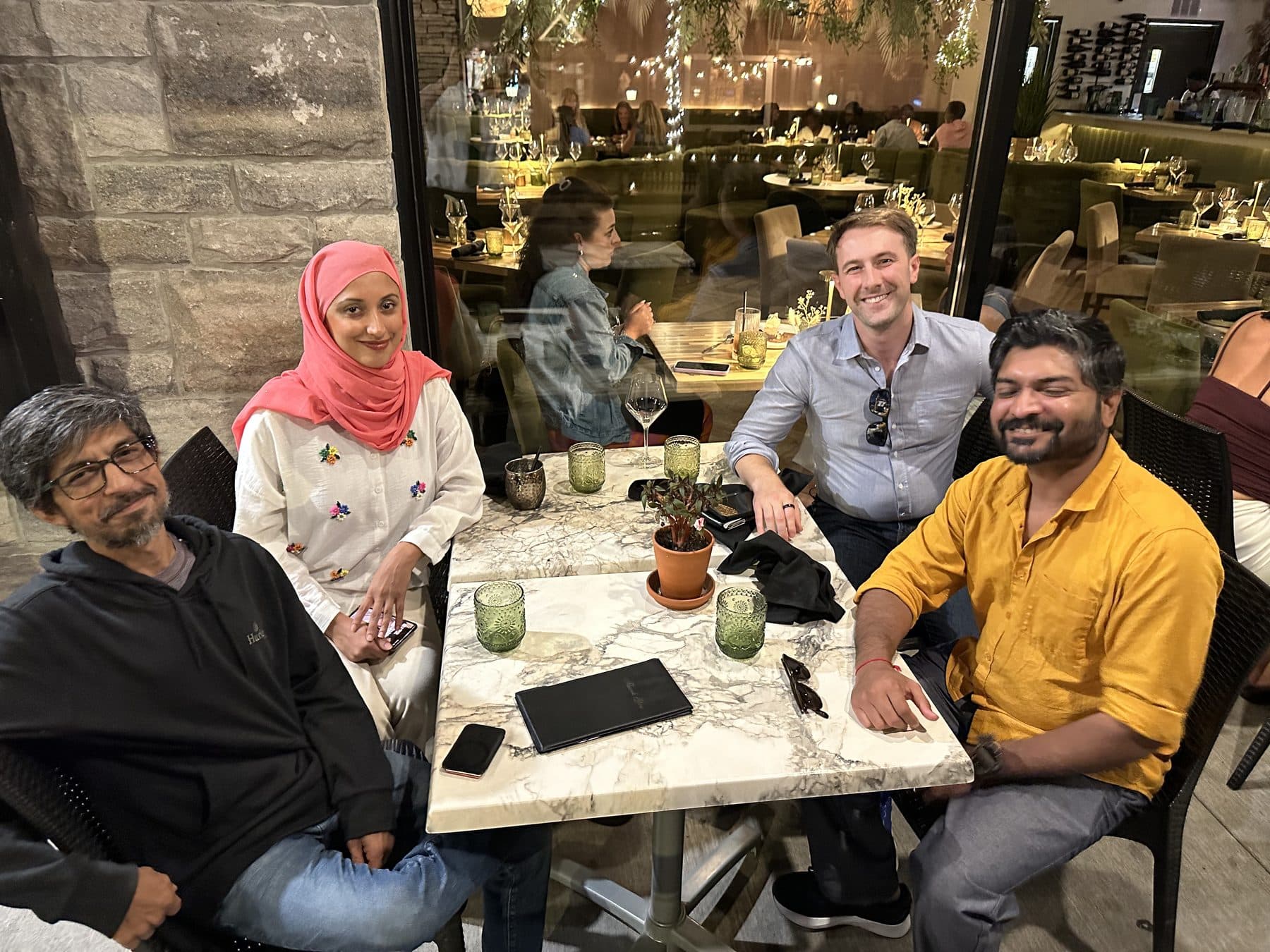 Four guests talking around a table at a Karmaflow AI agents dinner.